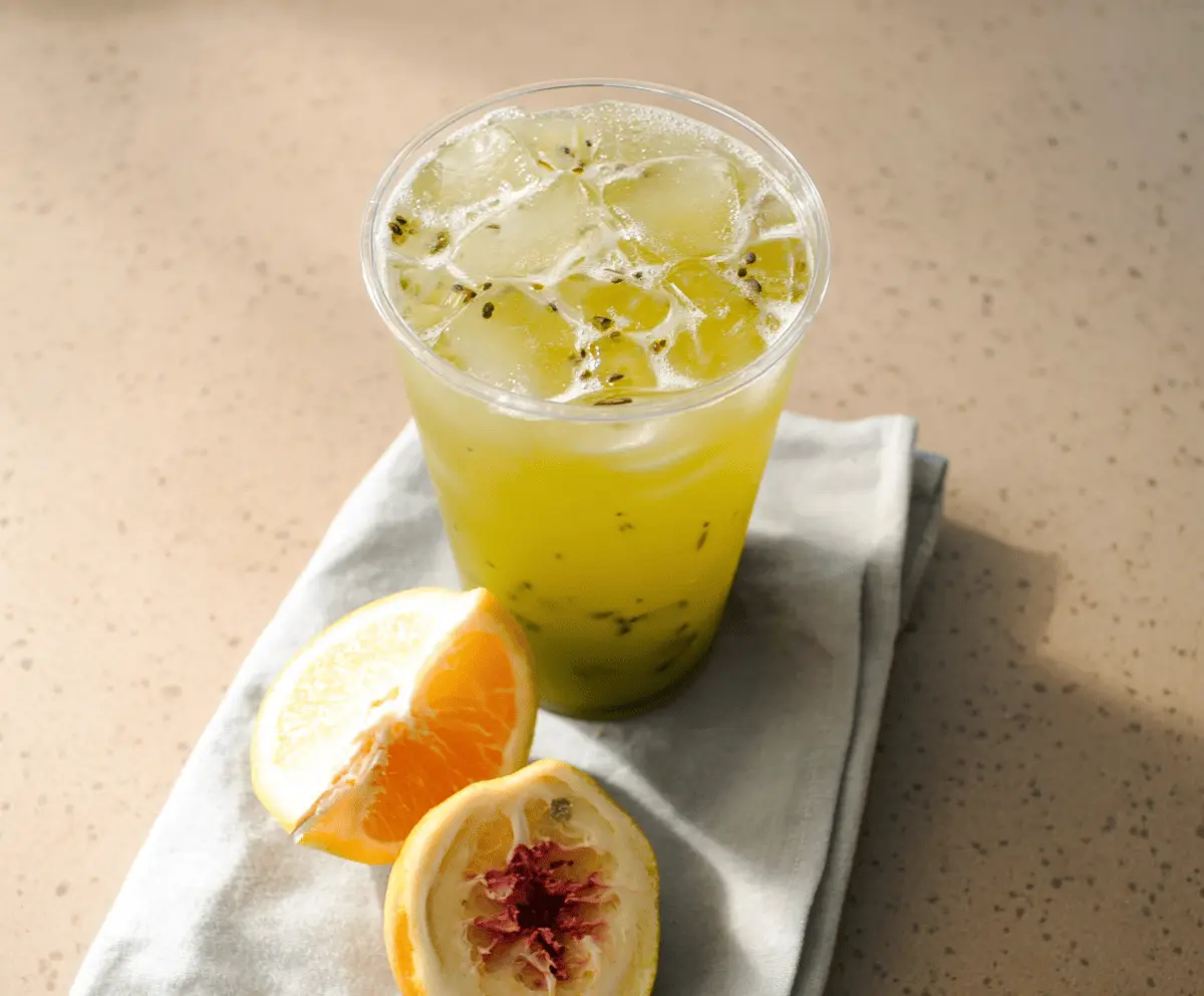 Creamy Panera Bread Copycat Green Tea in a glass mug with fresh mint leaves and lemon slices, served cold