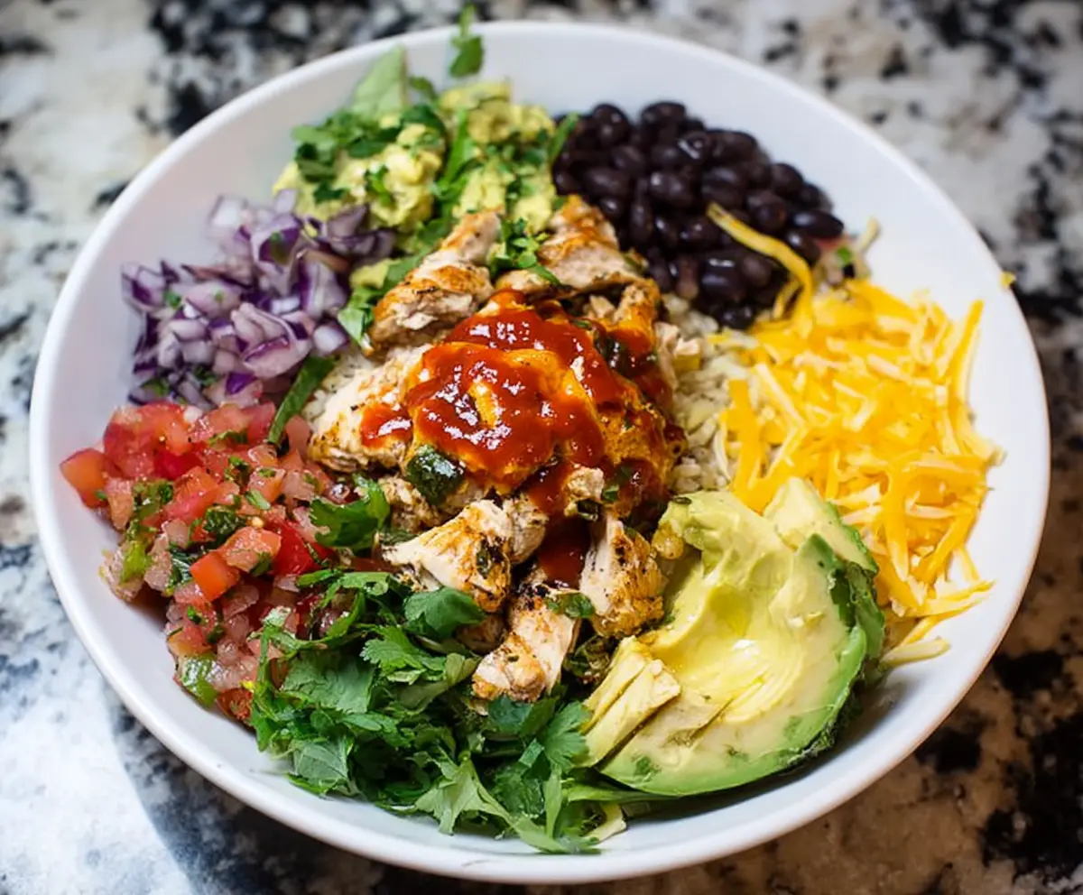 Delicious chicken burrito bowl with fresh vegetables and flavorful sauce