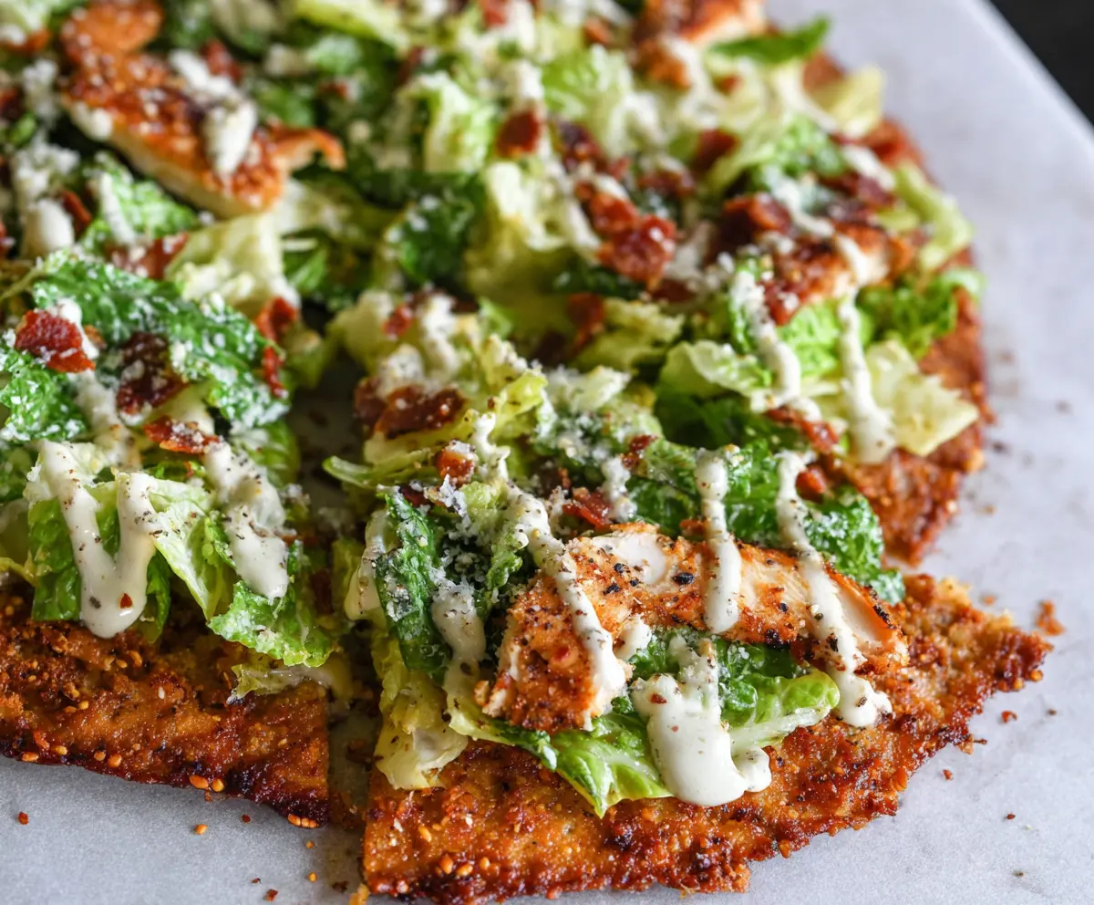 Delicious Chicken Crust Caesar Salad Pizza with crispy chicken crust and fresh Caesar salad toppings