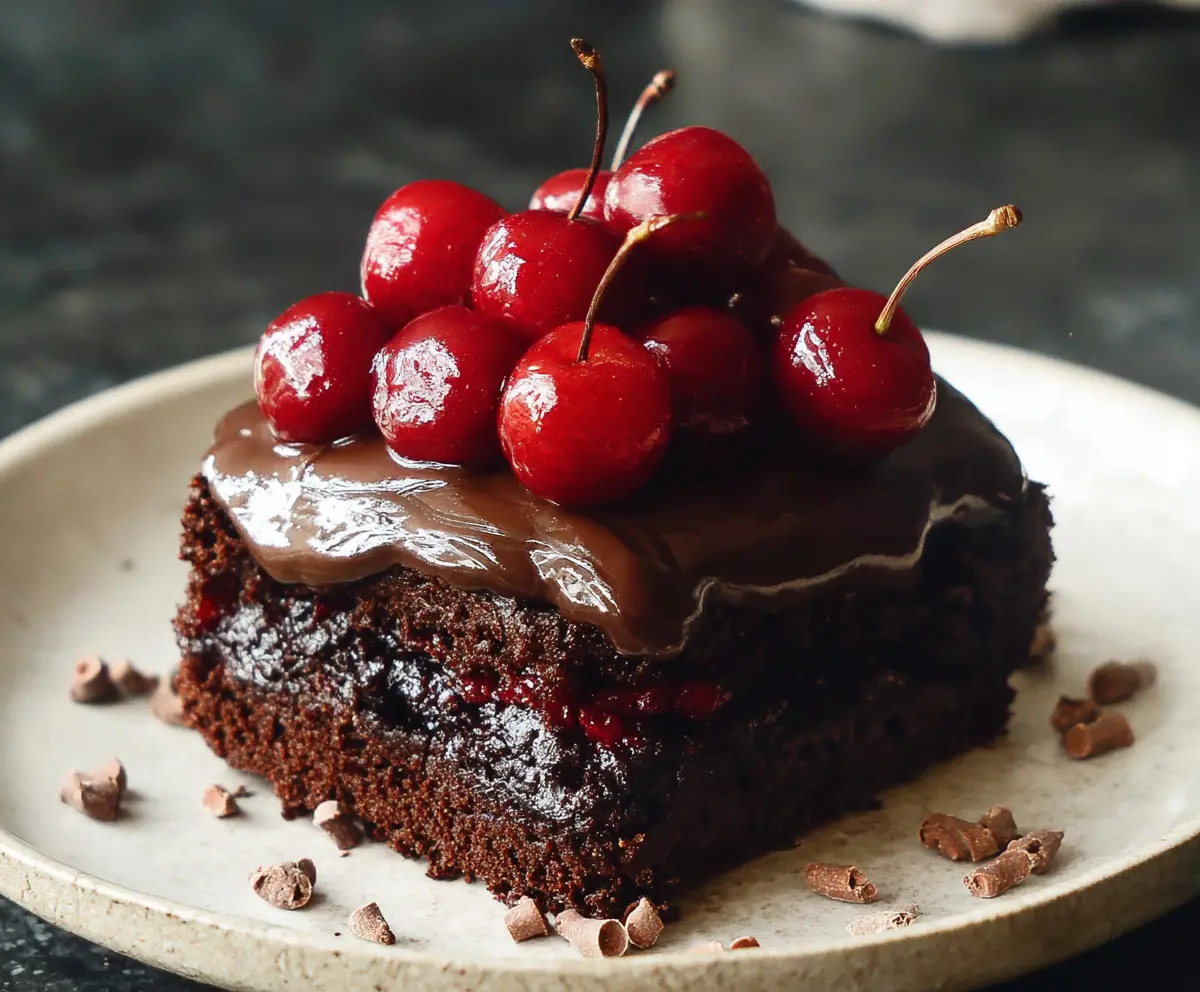 Delicious Chocolate Cherry Cake with rich chocolate frosting and fresh cherries on top
