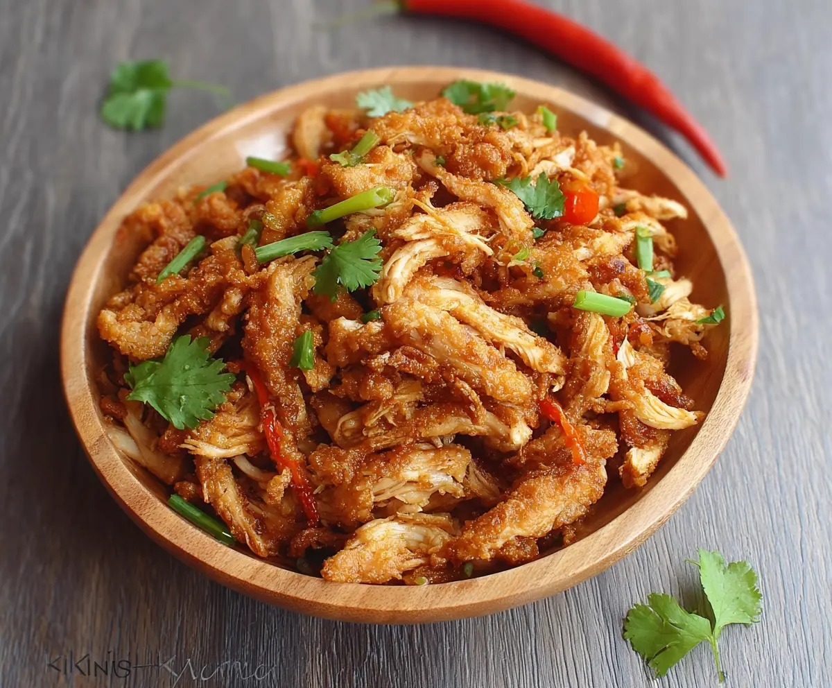 Delicious crispy shredded chicken served on a plate, perfect for a flavorful meal.