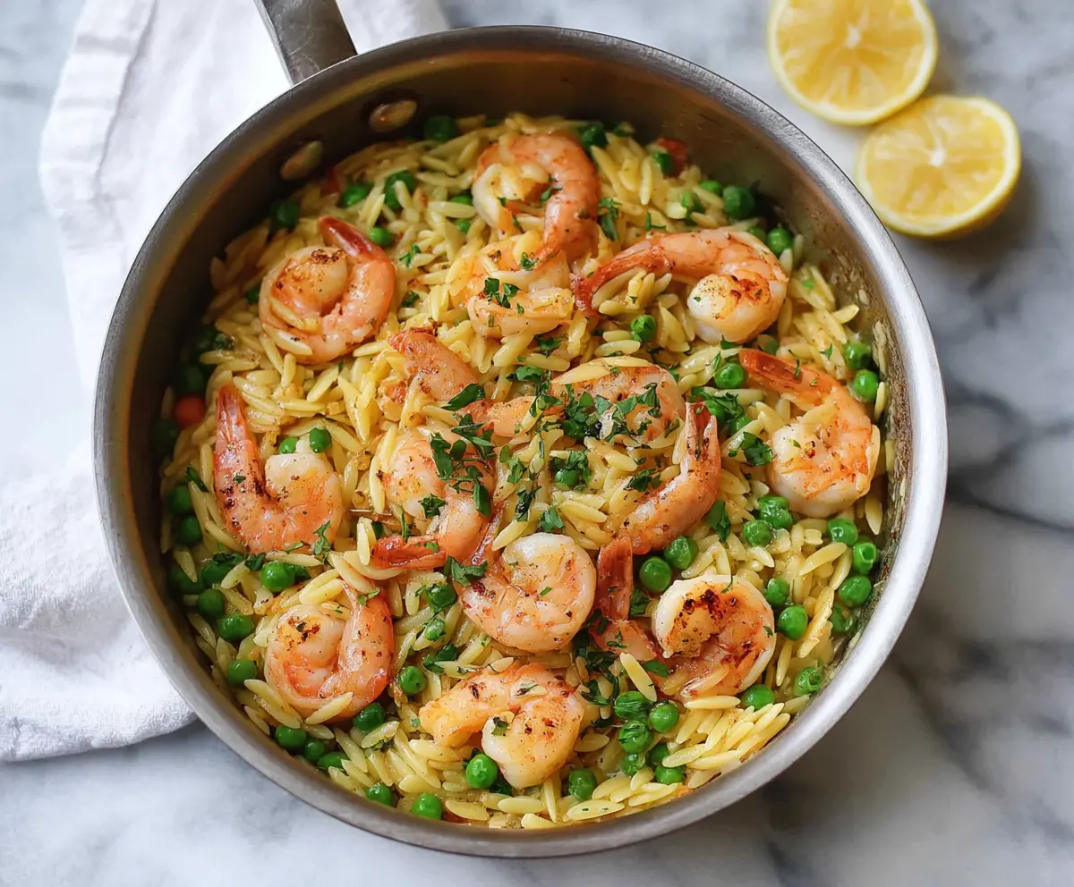 Delicious One Pot Pea and Shrimp Orzo served in a vibrant bowl, showcasing a flavorful seafood and vegetable pasta dish.